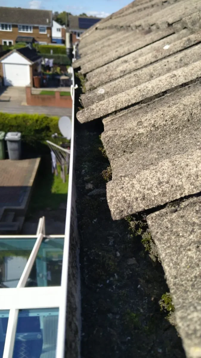 Roof tiles slipped into the  gutter in Rothwell making clearing difficult with vacuum.