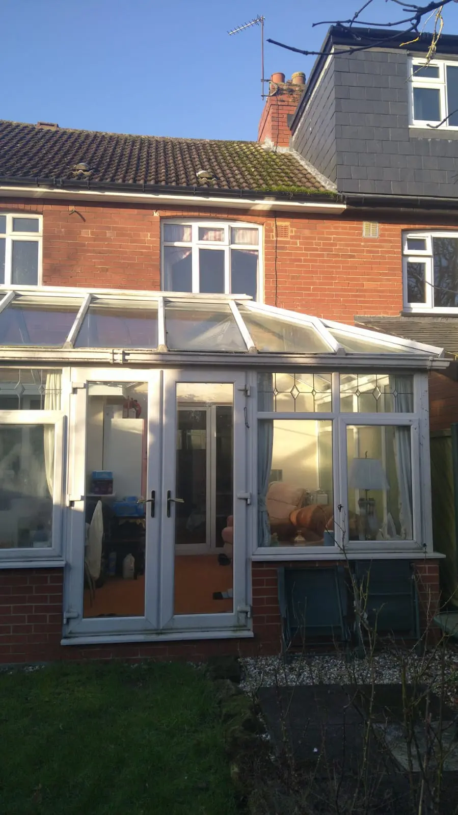 Tough gutter clear above conservatory in Leeds. Very difficult access due to full width conservatory.