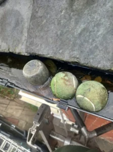 Tennis ball and plastic bottle caused the blockage in this Roundhay Gutter. In this case water was freezing and expanding the gutter joints. 